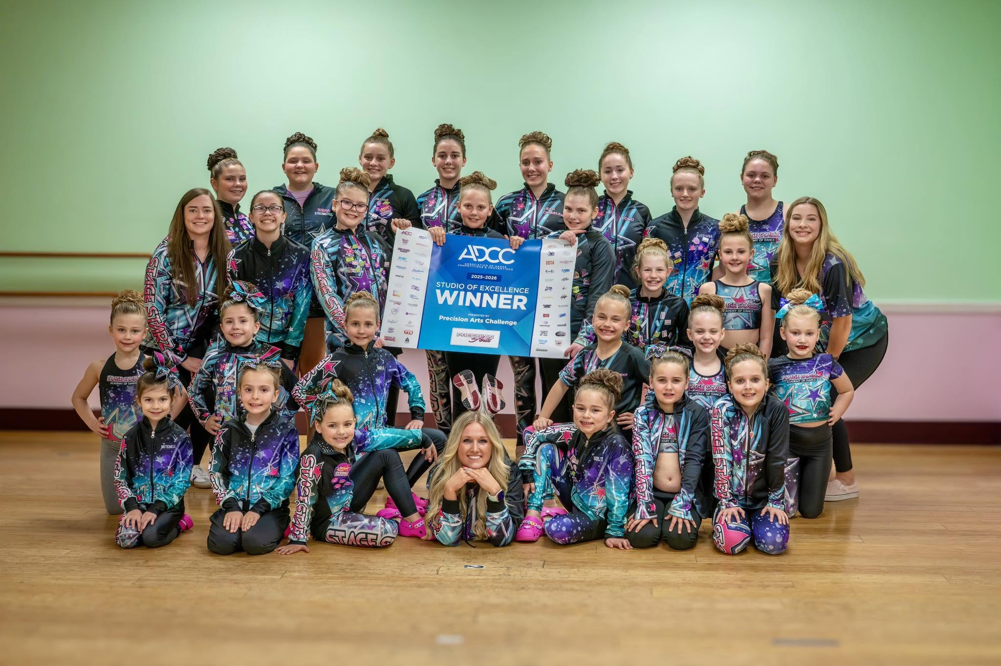Stage Starz competition dancers and instructors holding their Studio of Excellence award